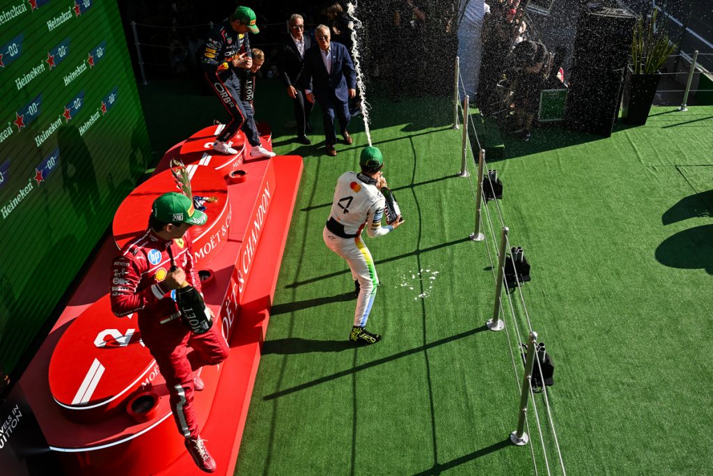 Top 3 finishers celebrating on podium after Mexico 2025 GP