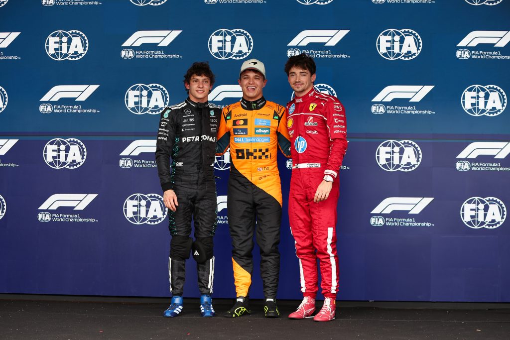 Top-three qualifiers backdrop: Norris centre, Antonelli left, Leclerc right.