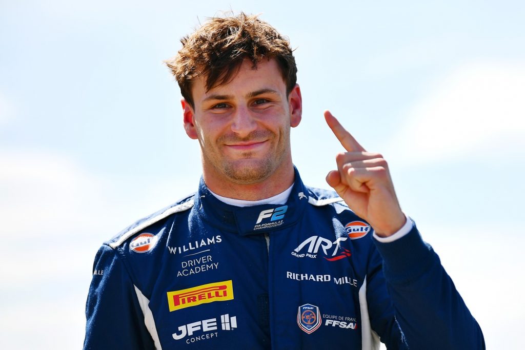 Winner of 2025 F2 Qatar Grand Prix, Victor Martins smiles in ART Grand Prix race suit, holding up one finger after winning race. 