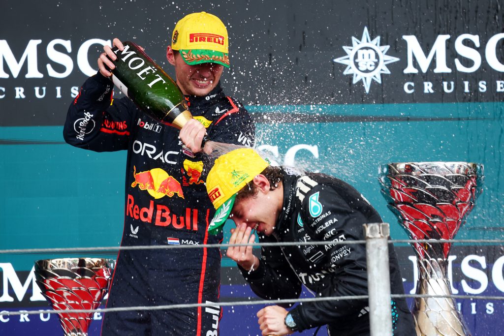 Podium celebration: Verstappen and Antonelli spraying champagne after the 2025 F1 Brazilian Grand Prix