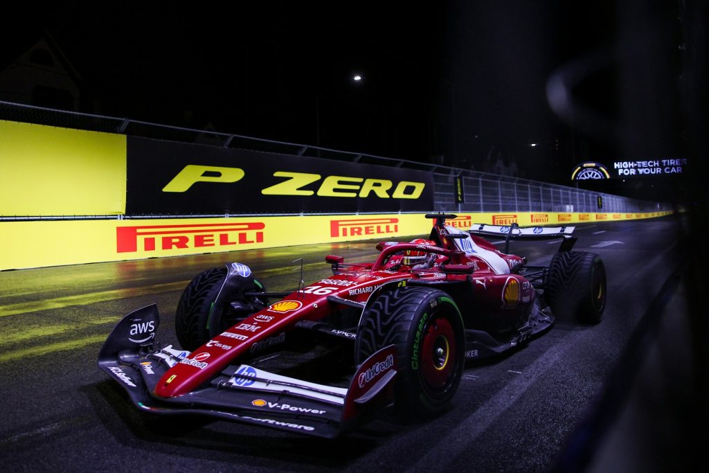 Charles Leclerc drives his Ferrari on intermediate tyres under the lights at the 2025 F1 Las Vegas Grand Prix.