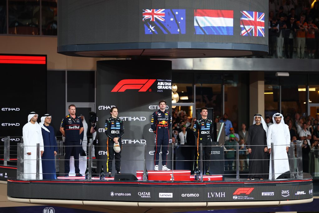 Race winner Max Verstappen, Second placed Oscar Piastri and 2025 F1 World Drivers Champion and Third placed Lando Norris on the podium during the 2025 F1 Abu Dhabi Grand Prix